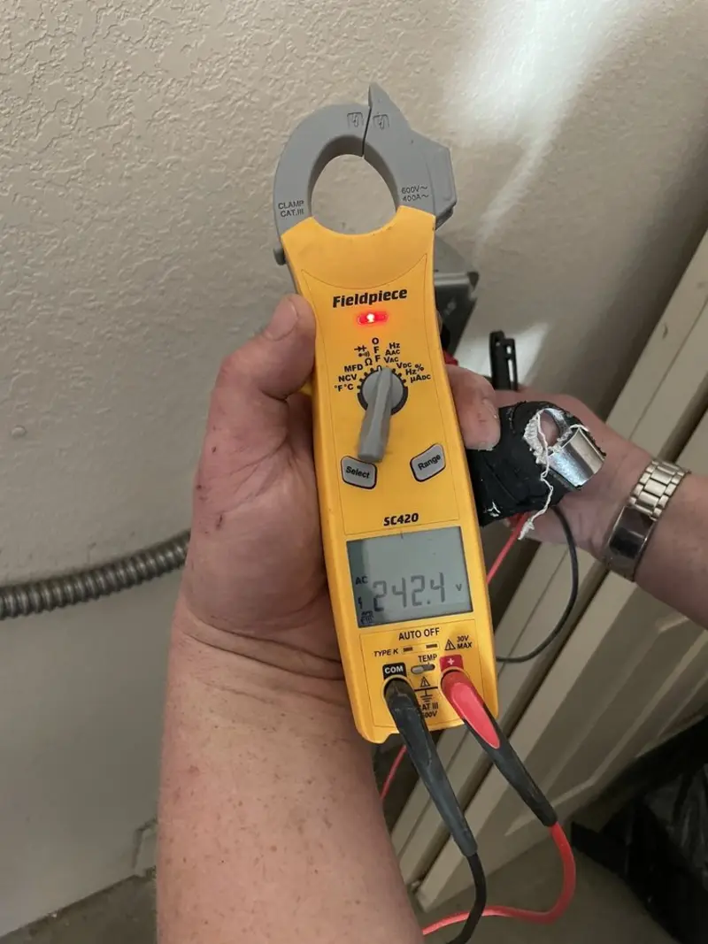 Voltage testing with clamp meter during Recessed Lighting Installation in Clayton